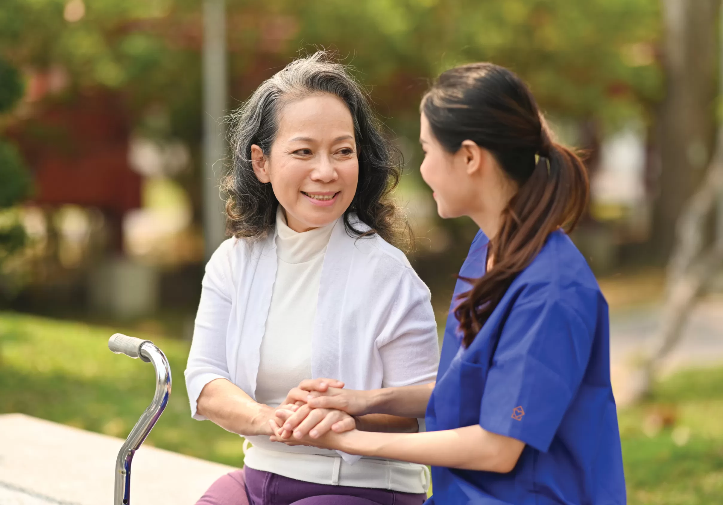 young-female-caregiver-talking-with-senior-woman-2023-04-14-16-31-28-utc
