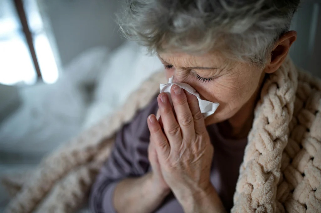 Senior woman with respiratory symptoms at home, a concern for family caregivers of parents with COPD